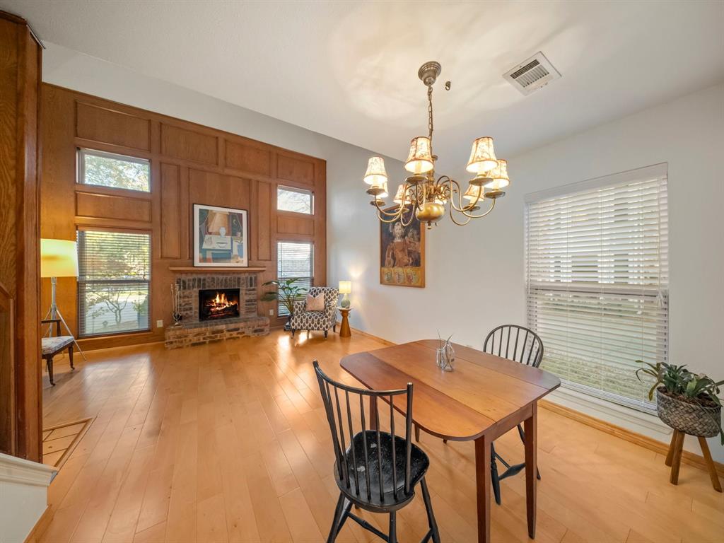 13347 Pandora Circle Dallas, TX 75238 - Photo 28 of 36 a view of a dining room with furniture a chandelier and wooden floor