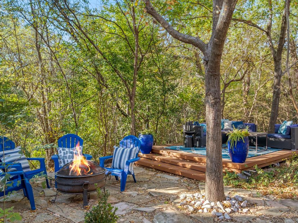 13347 Pandora Circle Dallas, TX 75238 - Photo 33 of 36 a backyard of a house with fountain table and chairs