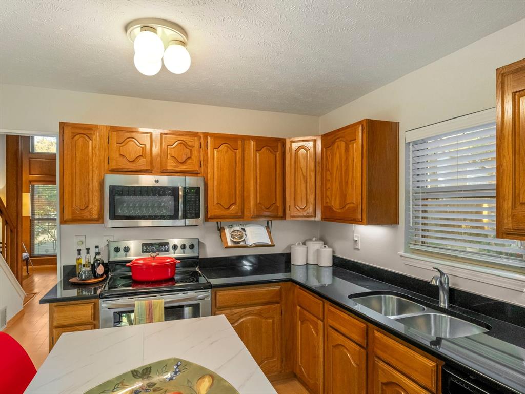 13347 Pandora Circle Dallas, TX 75238 - Photo 8 of 36 a kitchen that has a sink and a stove top oven