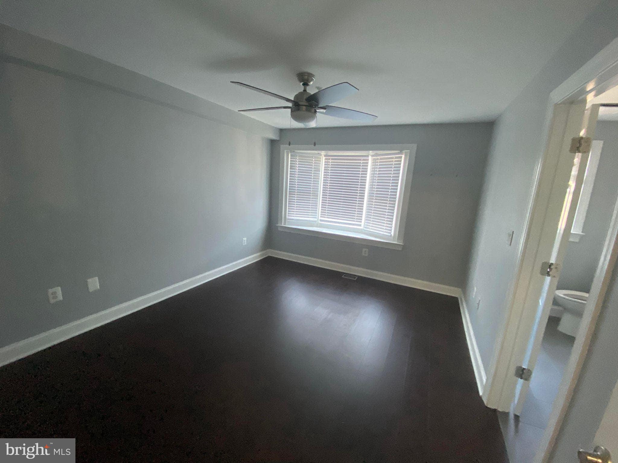 2256 South Garfield Street, Unit 11 Arlington, VA 22206 - Photo 19 of 21 an empty room with wooden floor fan and windows