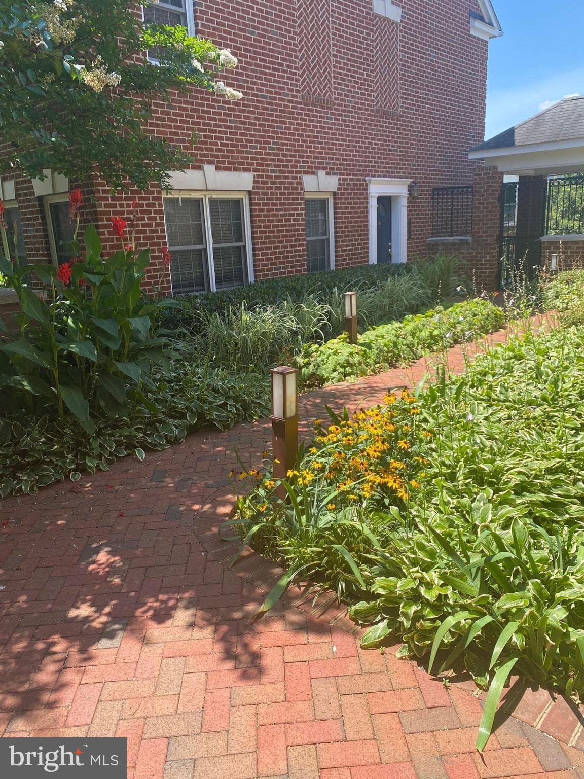 2256 South Garfield Street, Unit 11 Arlington, VA 22206 - Photo 7 of 21 a view of a brick house with a yard