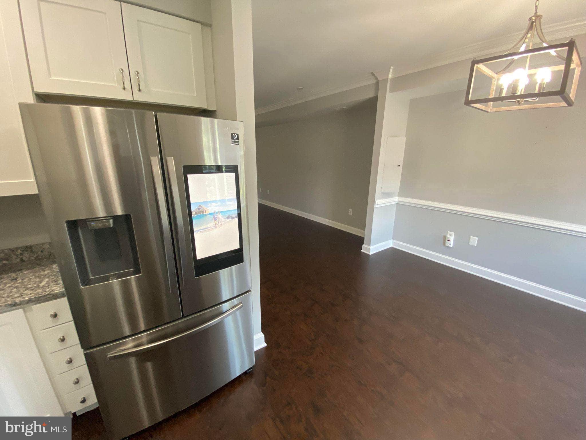 2256 South Garfield Street, Unit 11 Arlington, VA 22206 - Photo 10 of 21 a view of a refrigerator in kitchen and an empty room