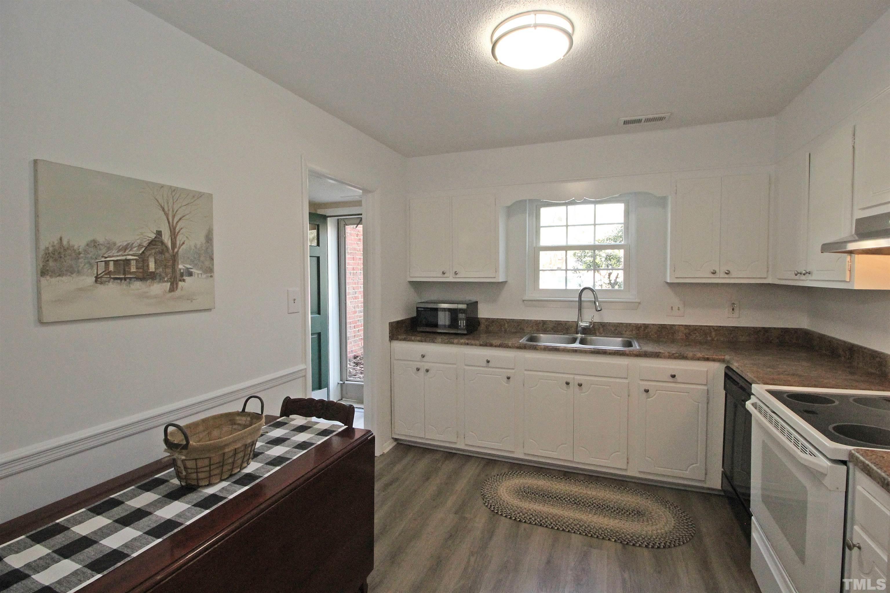 1204 Falls Church Road, Unit C Raleigh, NC 27609 - Photo 13 of 26 a kitchen that has a sink and a stove in it