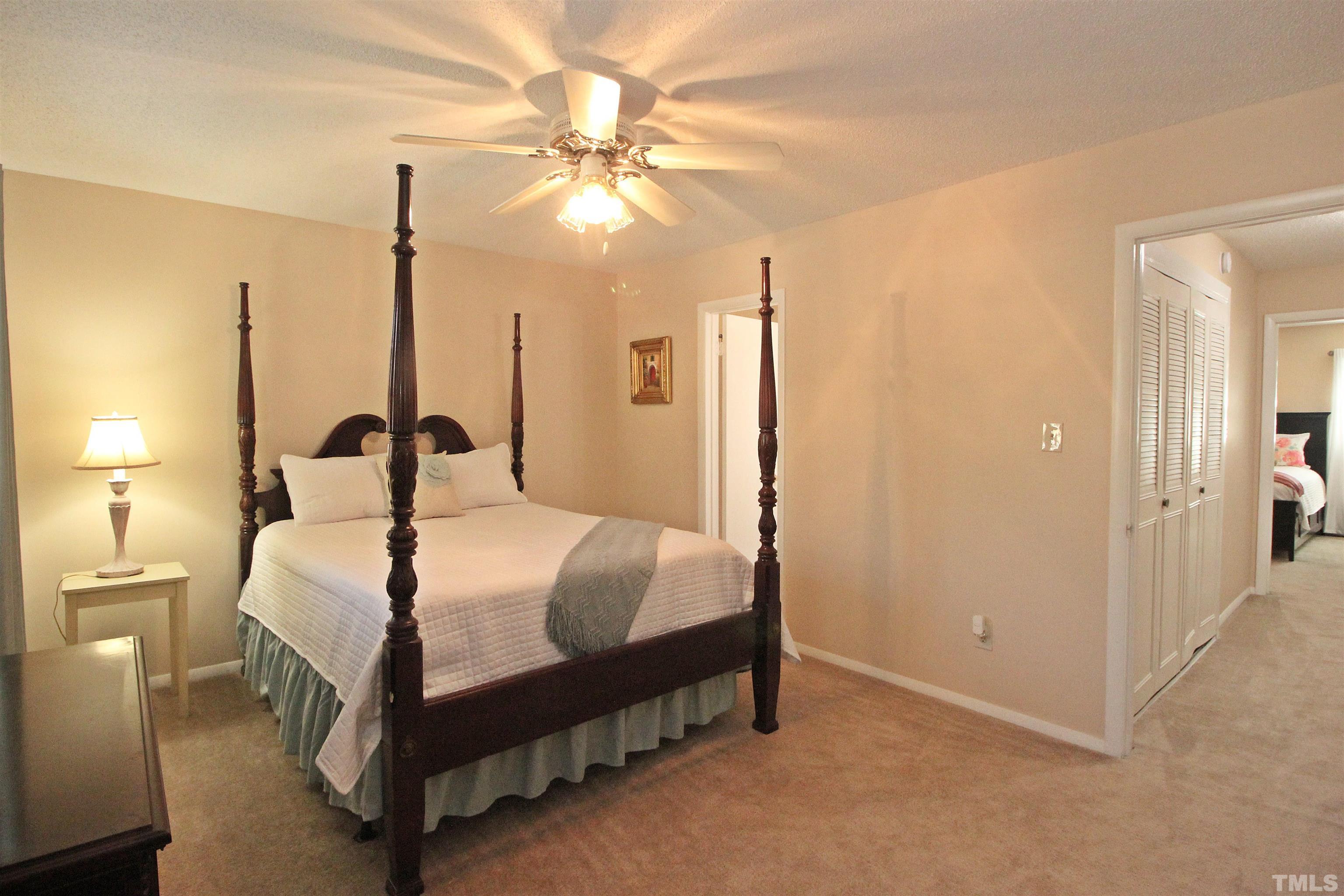 1204 Falls Church Road, Unit C Raleigh, NC 27609 - Photo 20 of 26 a bedroom with a bed and a chandelier