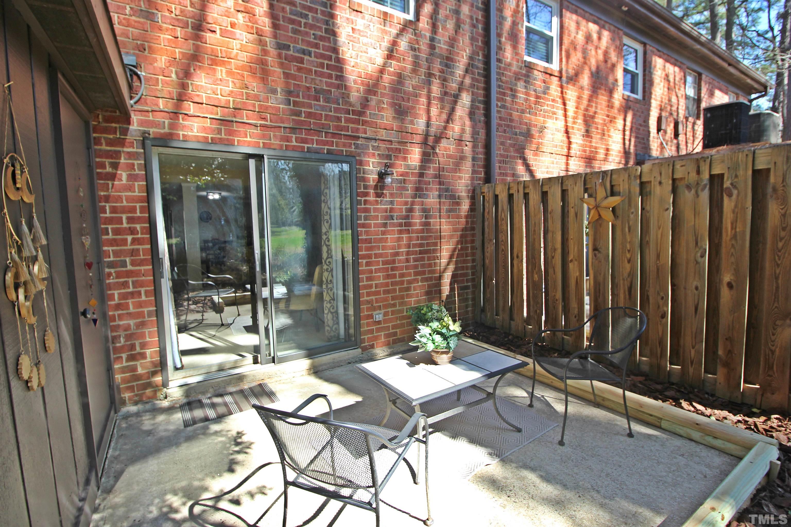 1204 Falls Church Road, Unit C Raleigh, NC 27609 - Photo 23 of 26 a backyard of a house with table and chairs