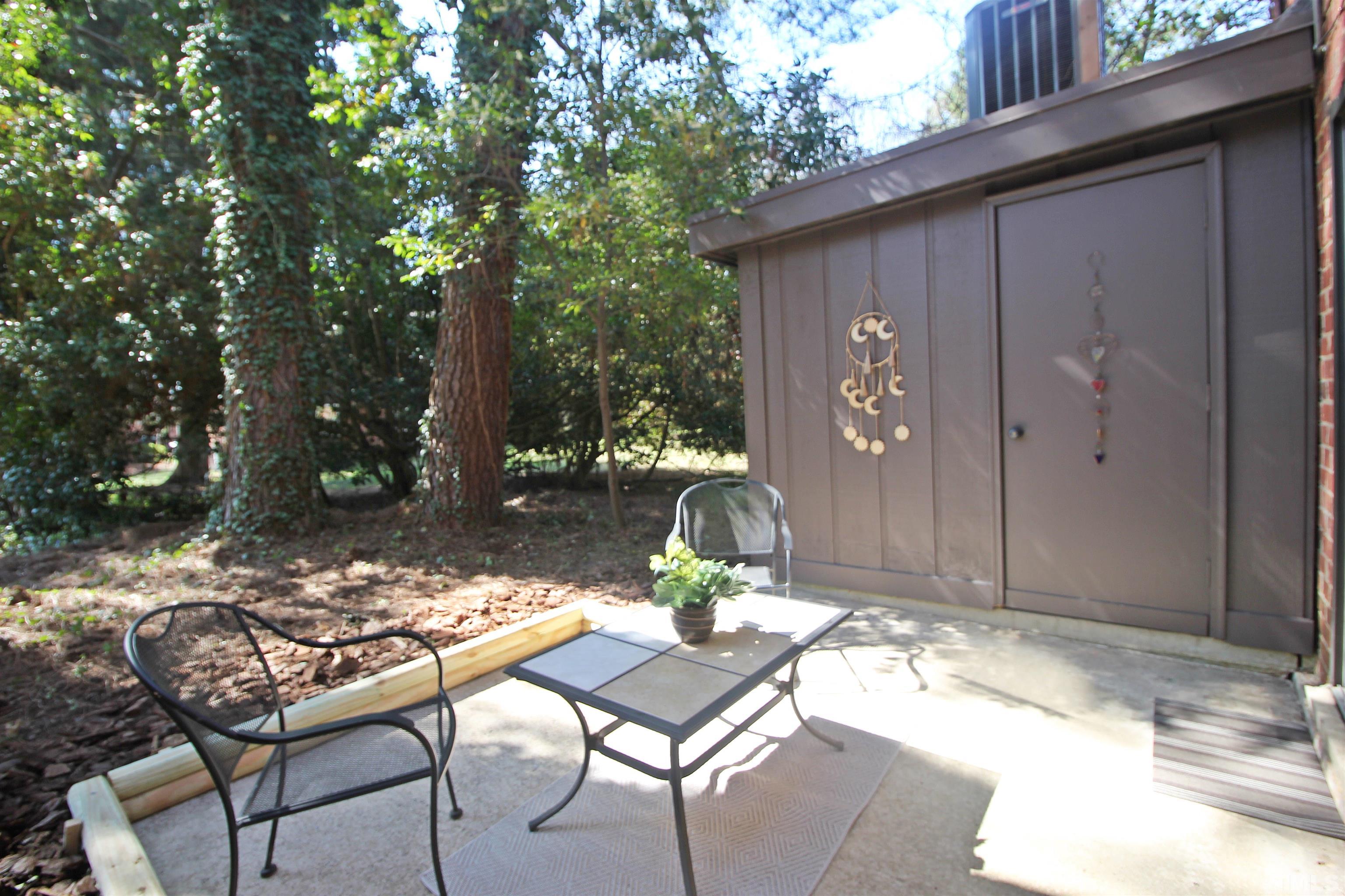 1204 Falls Church Road, Unit C Raleigh, NC 27609 - Photo 26 of 26 a backyard of a house with table and chairs