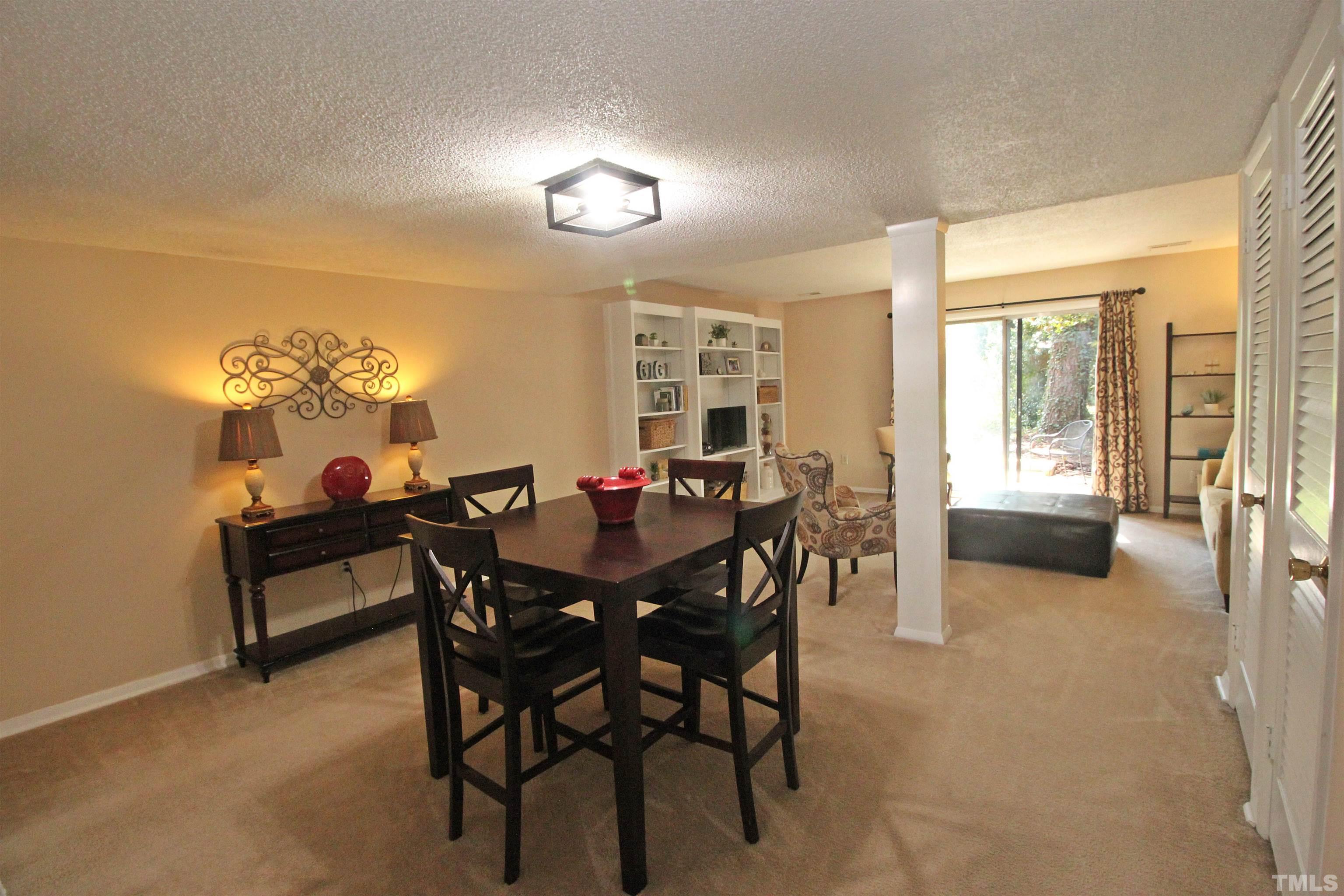 1204 Falls Church Road, Unit C Raleigh, NC 27609 - Photo 4 of 26 a dining room with furniture and a livingroom