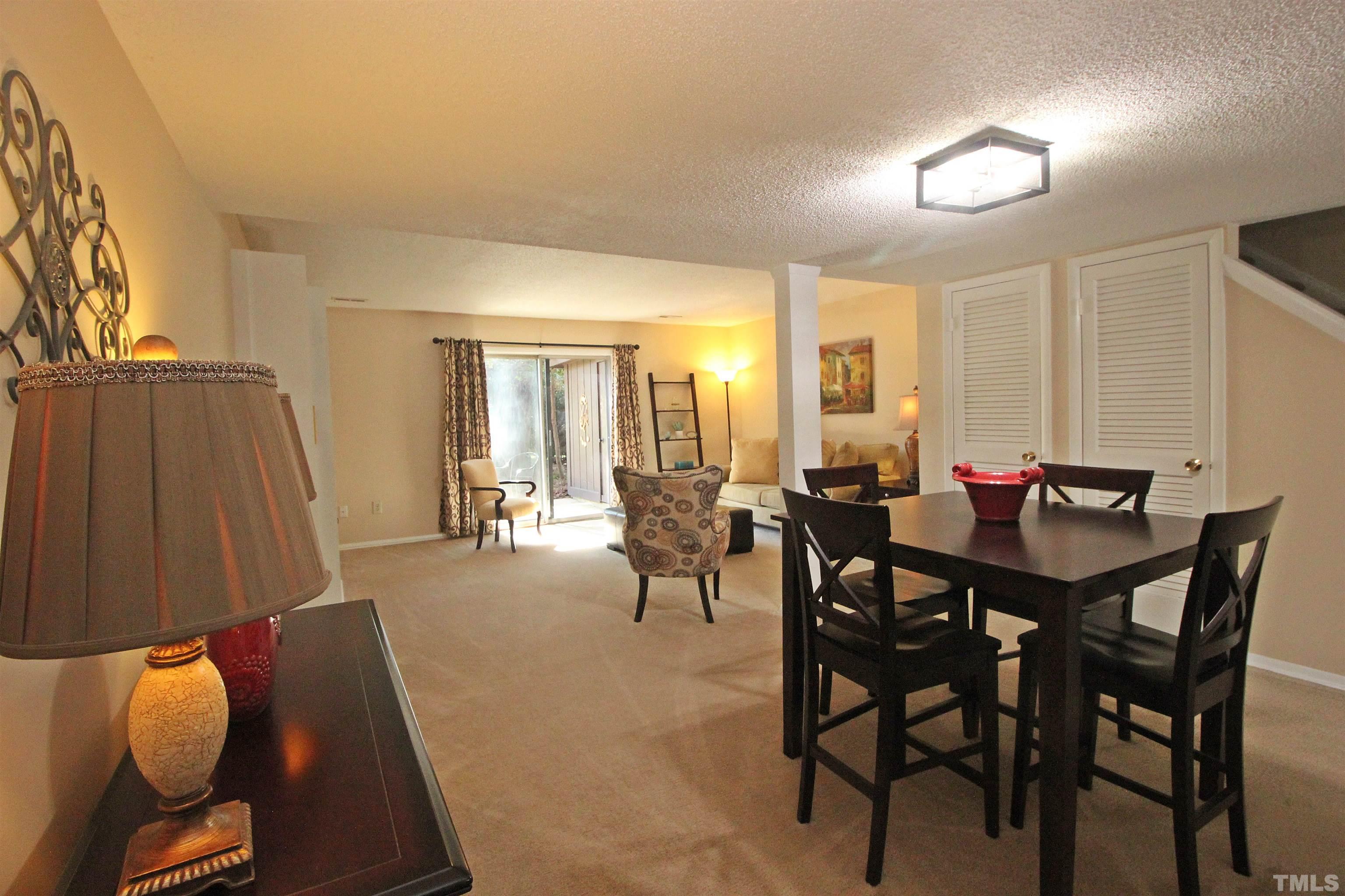 1204 Falls Church Road, Unit C Raleigh, NC 27609 - Photo 6 of 26 a view of a dining room with furniture and a table