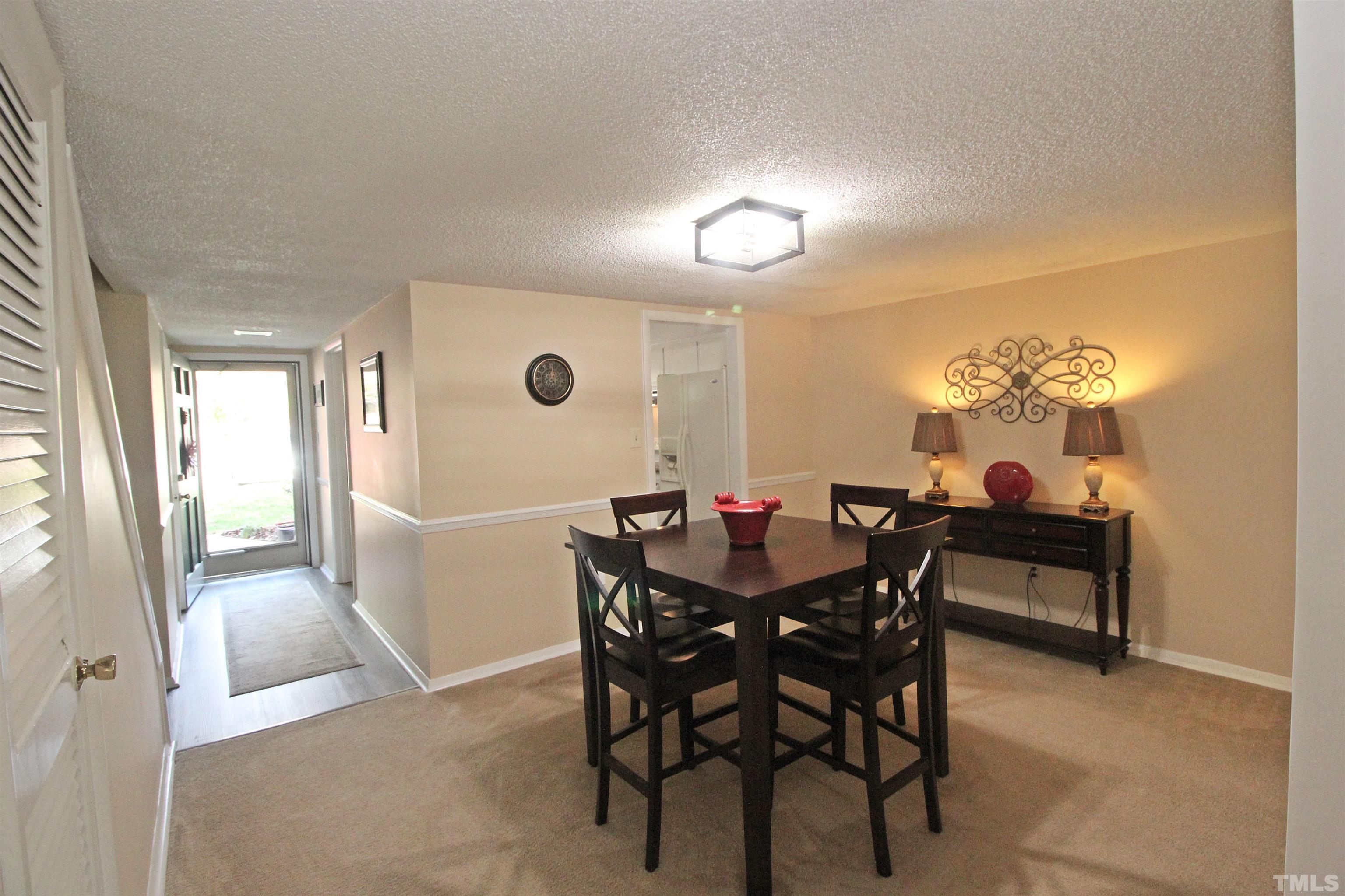 1204 Falls Church Road, Unit C Raleigh, NC 27609 - Photo 7 of 26 a view of a dining room with furniture and a potted plant