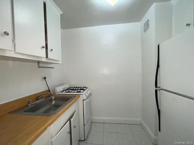 62-59 108th Street, Unit 5C Queens, NY 11375 - Photo 4 of 8 a kitchen with a sink and a stove top oven