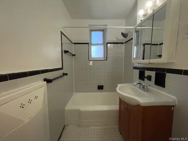 a bathroom with a sink mirror vanity and toilet