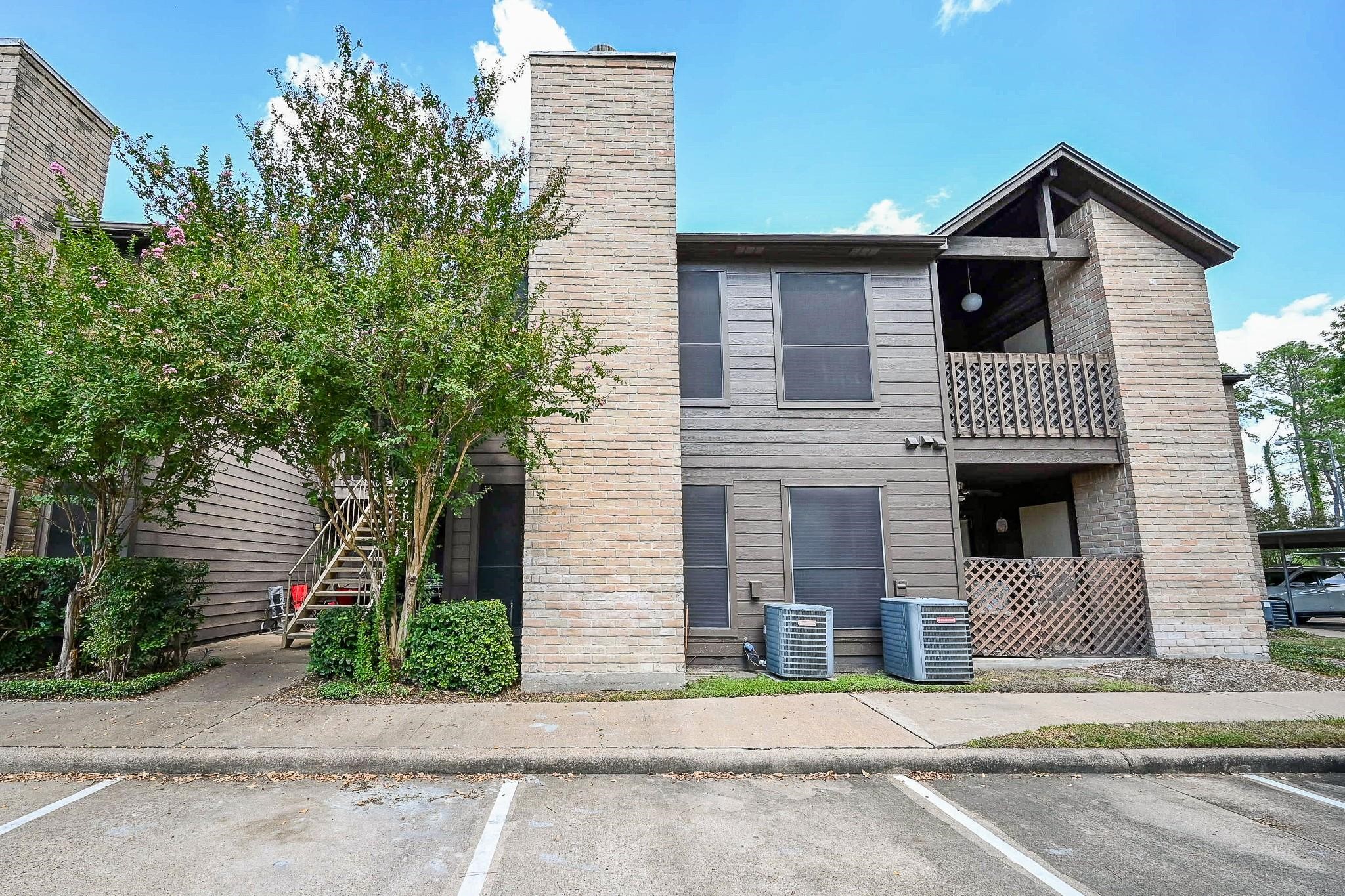 12755 Mill Ridge Drive, Unit 217 Cypress, TX 77429 - Photo 13 of 17 a view of a house with a yard and potted plants