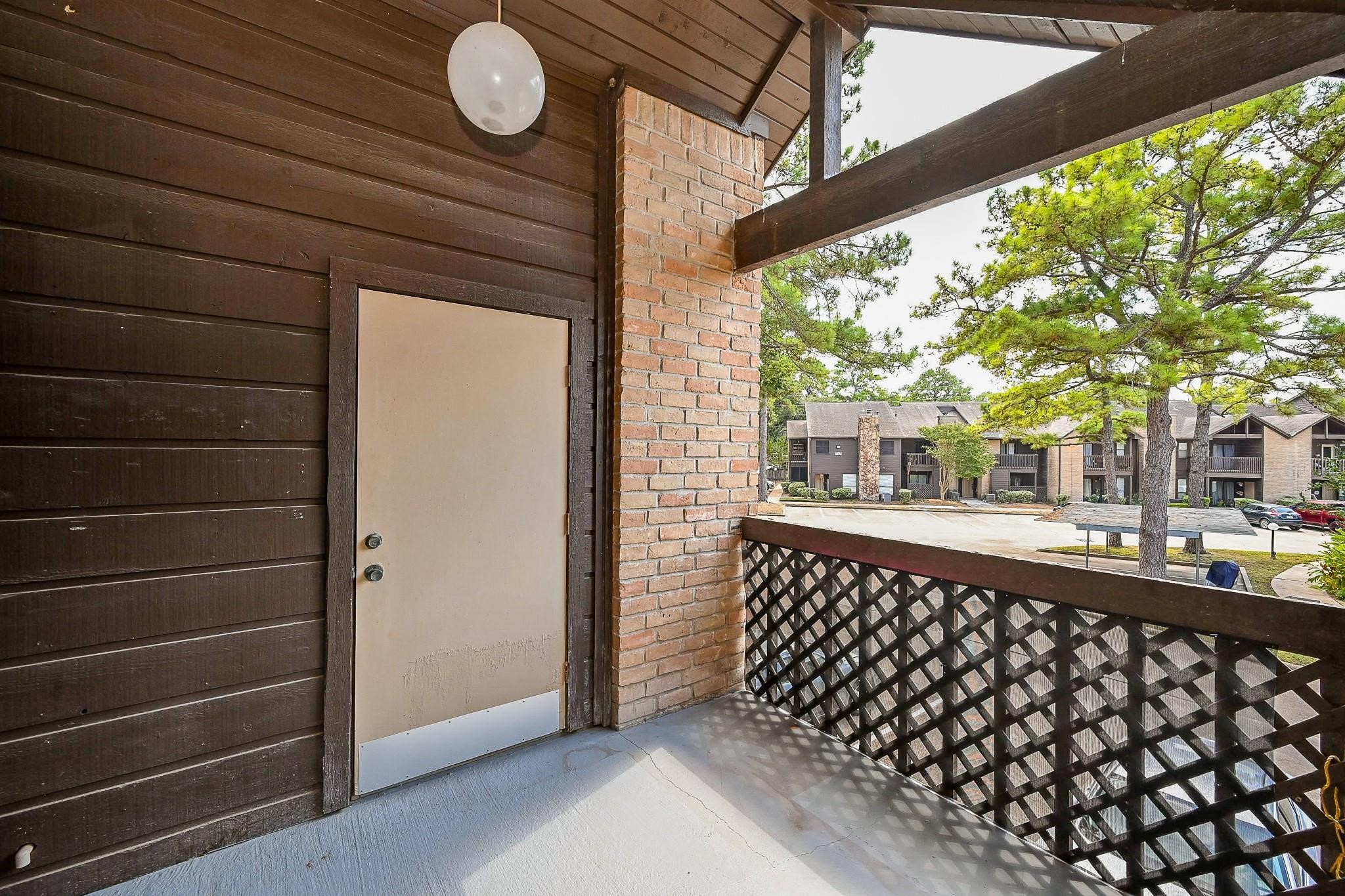 12755 Mill Ridge Drive, Unit 217 Cypress, TX 77429 - Photo 14 of 17 a view of a porch with wooden floor