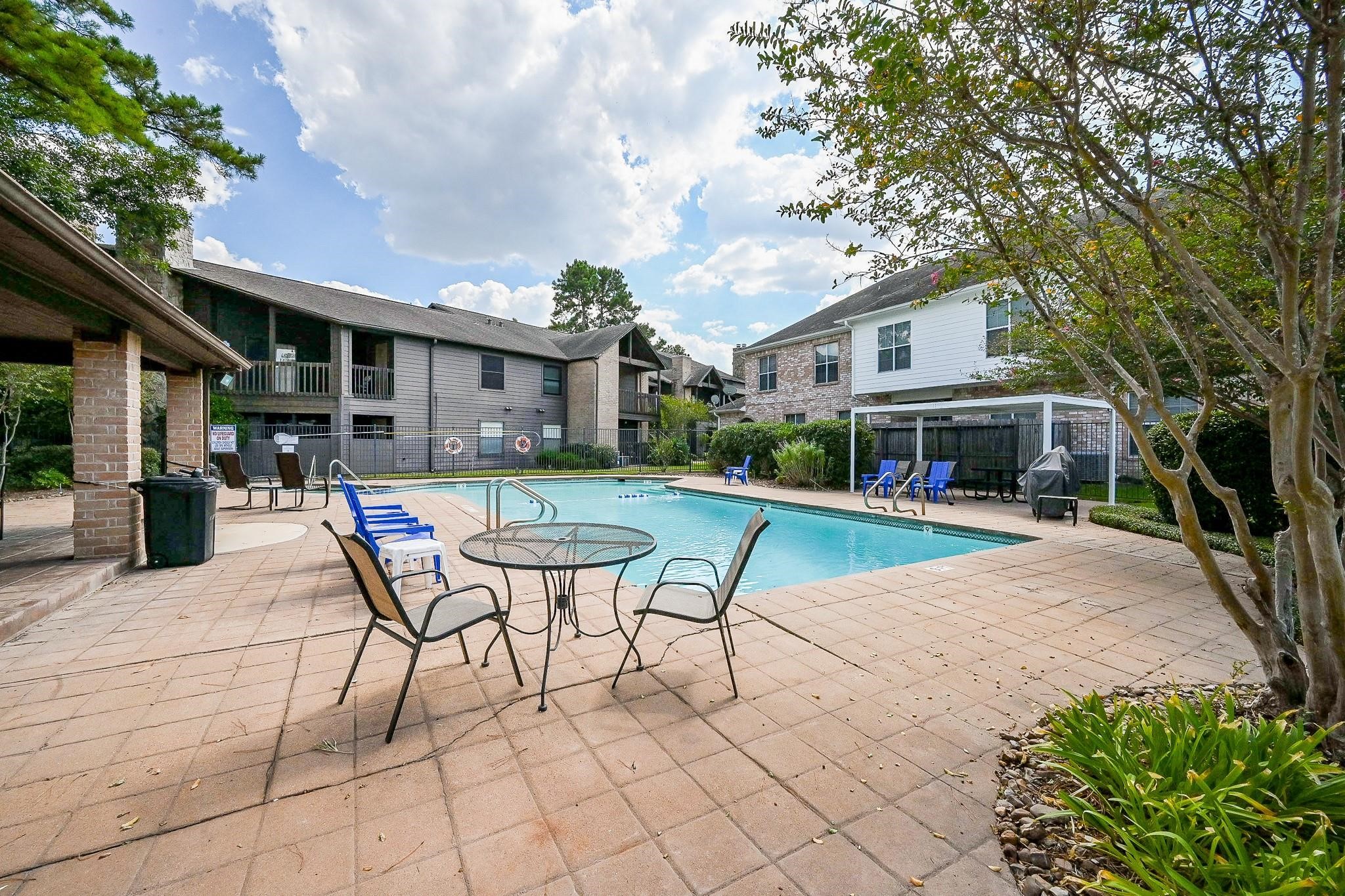 12755 Mill Ridge Drive, Unit 217 Cypress, TX 77429 - Photo 16 of 17 a swimming pool with outdoor seating and yard