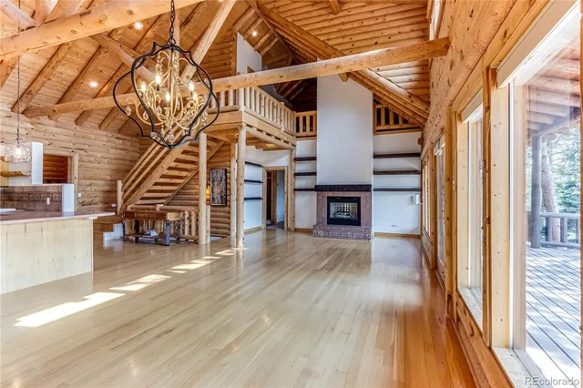 a view of a livingroom with wooden floor and stairs