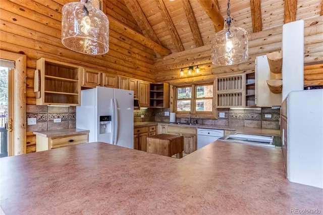 a kitchen that has a lot of cabinets in it