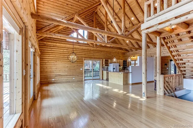 a view of a porch with wooden floor and floor to ceiling windows