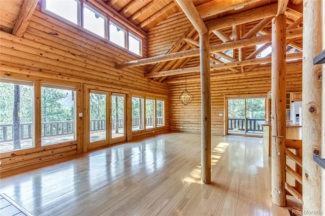 a bedroom with a bed next to a window with a bed