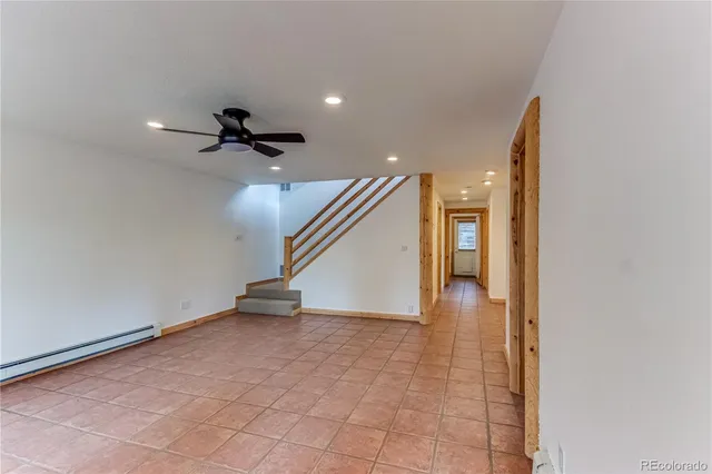 a bedroom with a bed and a dresser next to a window