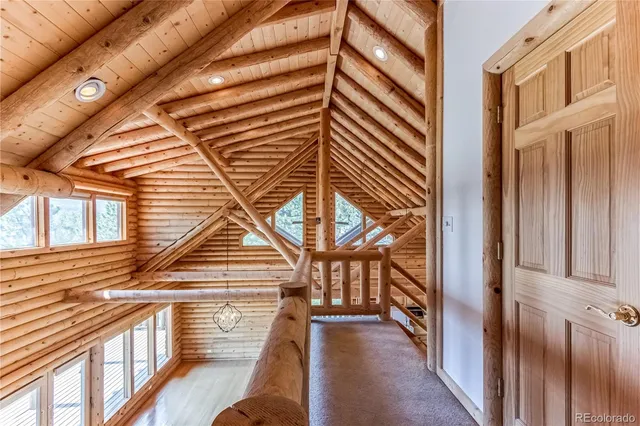 a view of a house with a yard and wooden fence