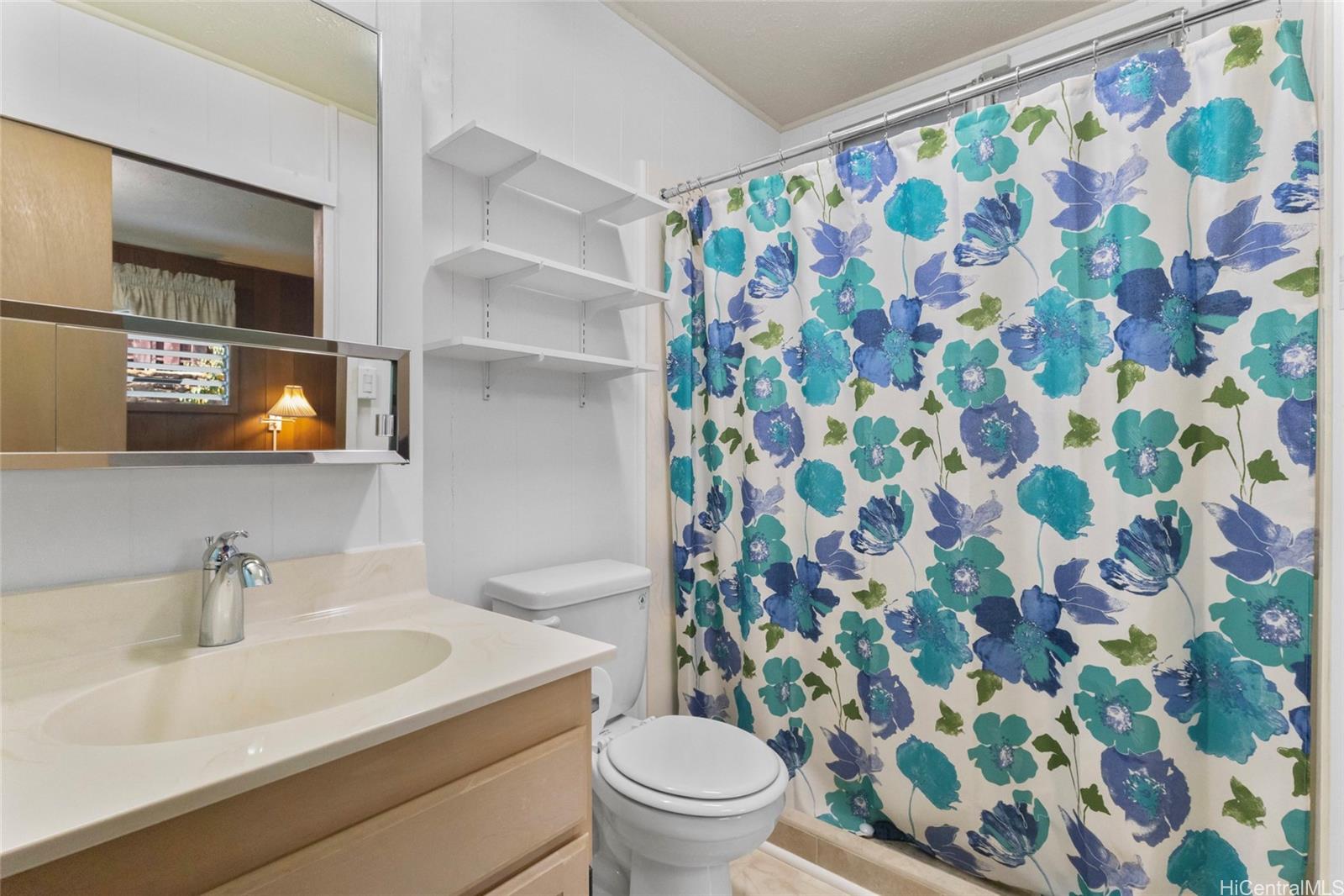 94-341 Kahuanani Street Waipahu, HI 96797 - Photo 12 of 24 a bathroom with a sink and mirror with toilet