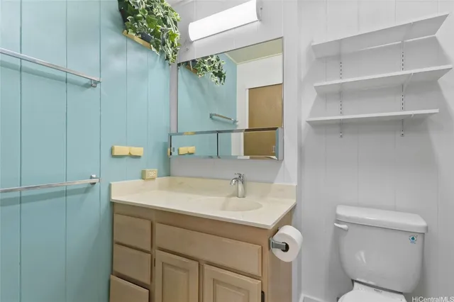 a bathroom with a sink toilet and mirror