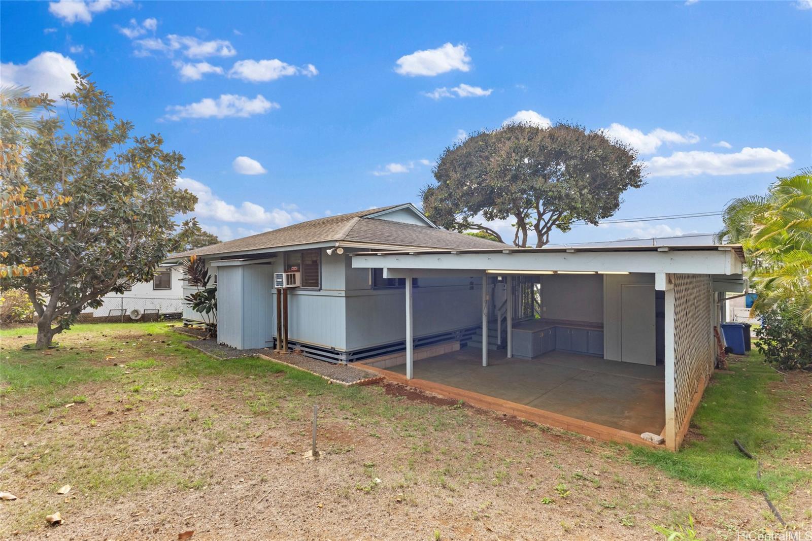 94-341 Kahuanani Street Waipahu, HI 96797 - Photo 17 of 24 a view of a house with a yard and garage