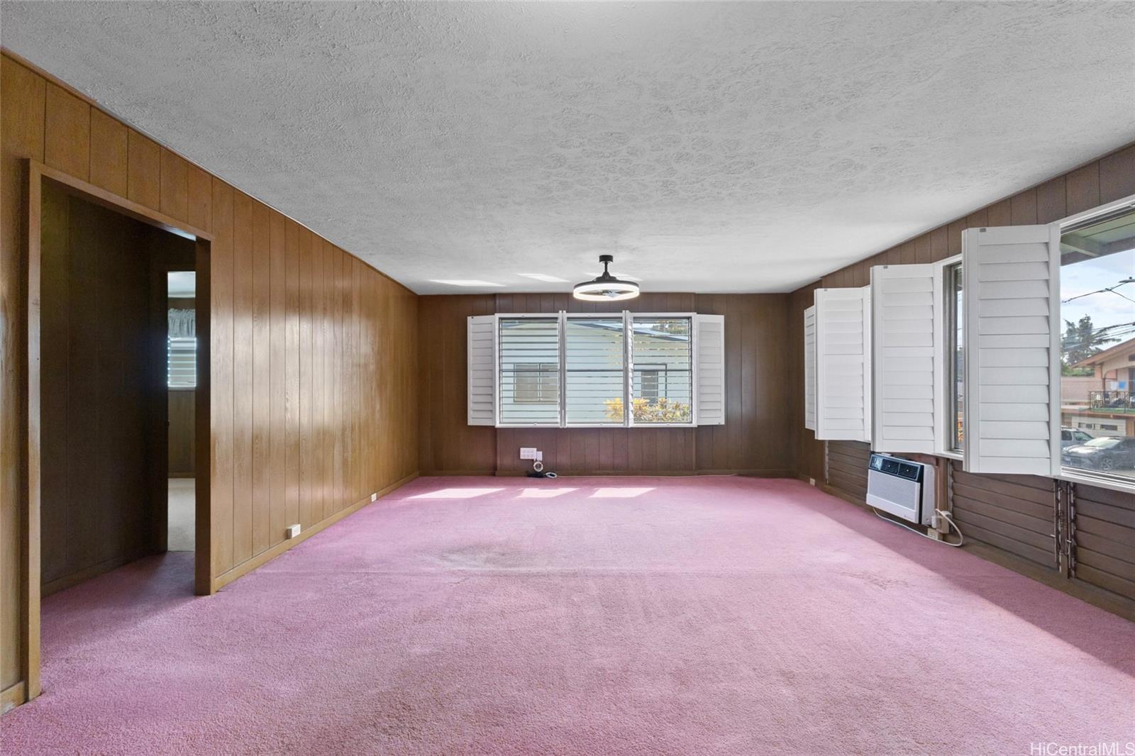 94-341 Kahuanani Street Waipahu, HI 96797 - Photo 4 of 24 an empty room with windows and cabinet