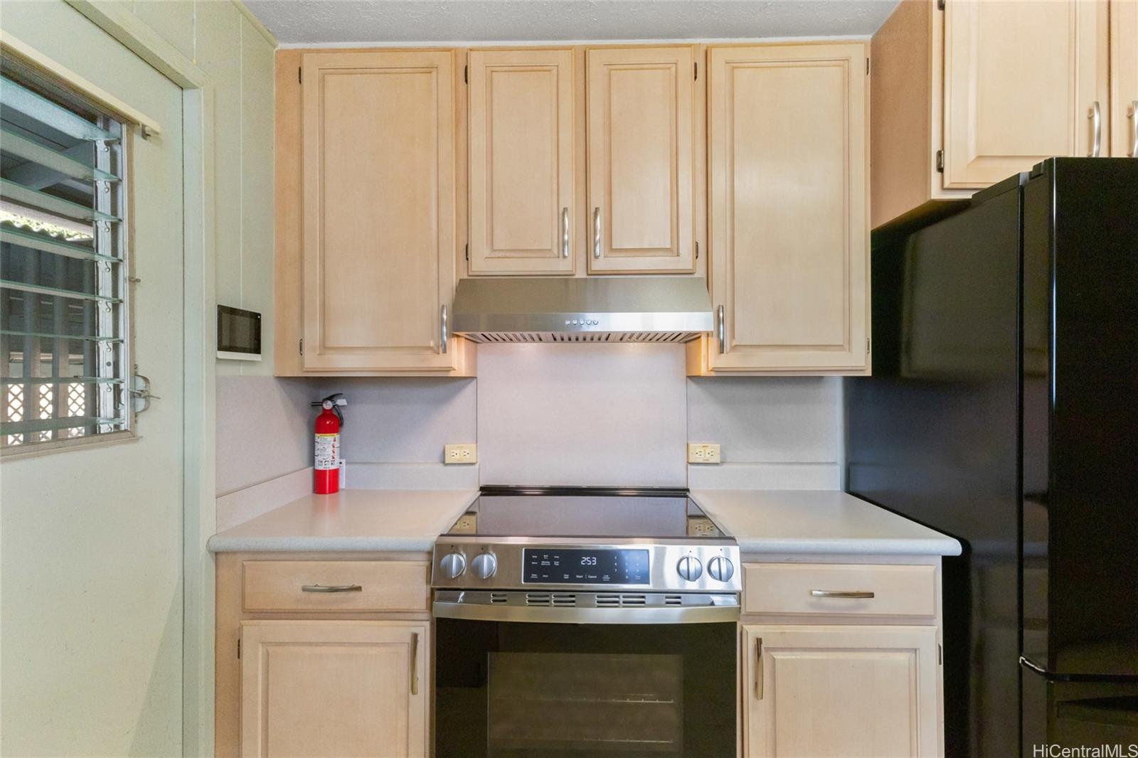 94-341 Kahuanani Street Waipahu, HI 96797 - Photo 5 of 24 a stove top oven sitting inside of a kitchen