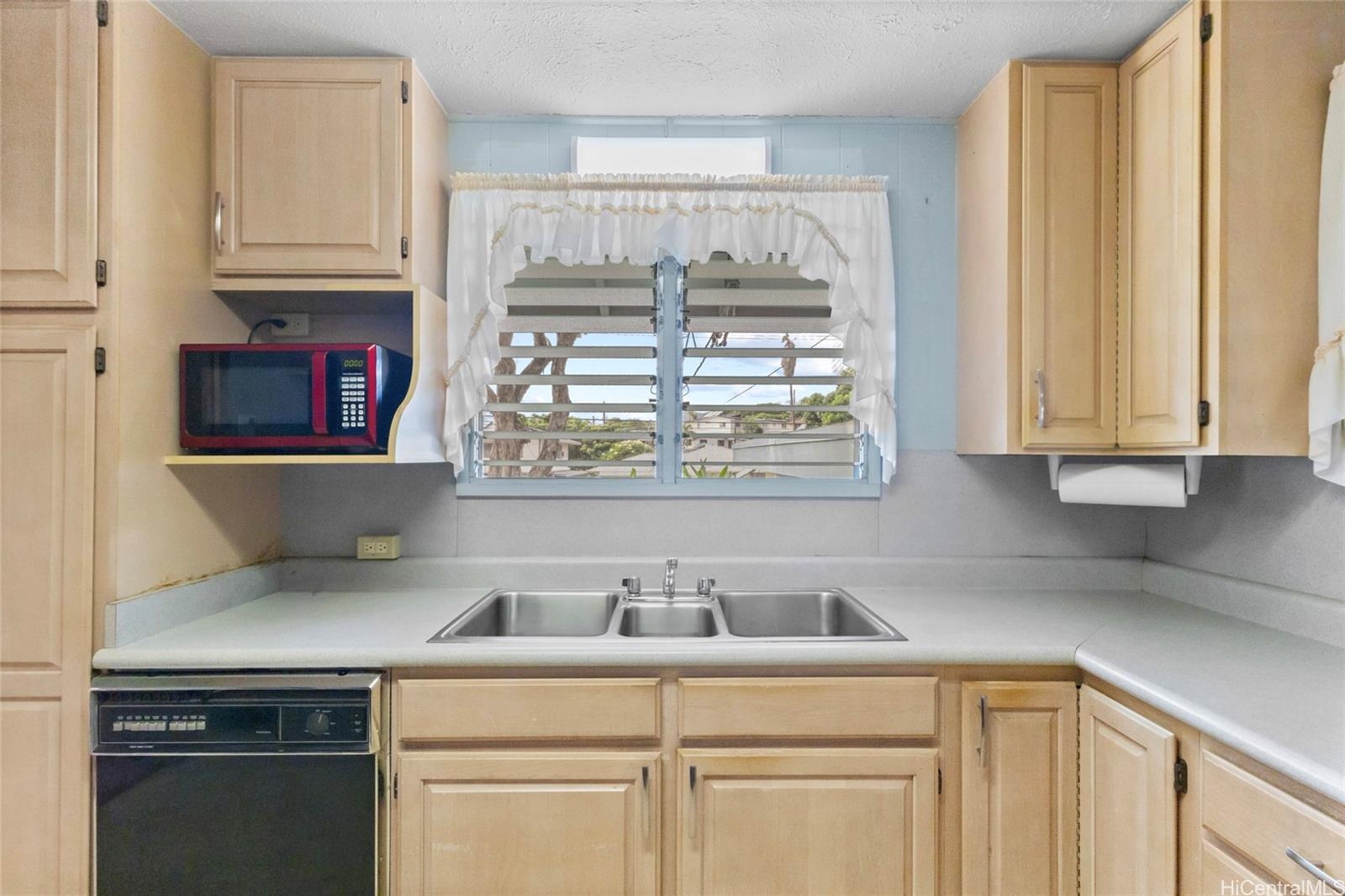 94-341 Kahuanani Street Waipahu, HI 96797 - Photo 6 of 24 a kitchen with stainless steel appliances granite countertop a sink and a white cabinets