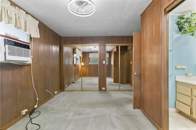 a view of a hallway with wooden cabinets