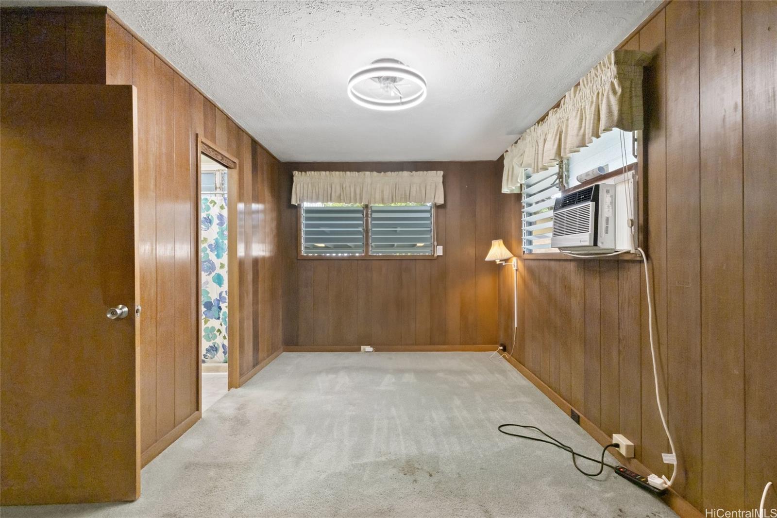 94-341 Kahuanani Street Waipahu, HI 96797 - Photo 9 of 24 a view of an empty room with wooden floor and a window