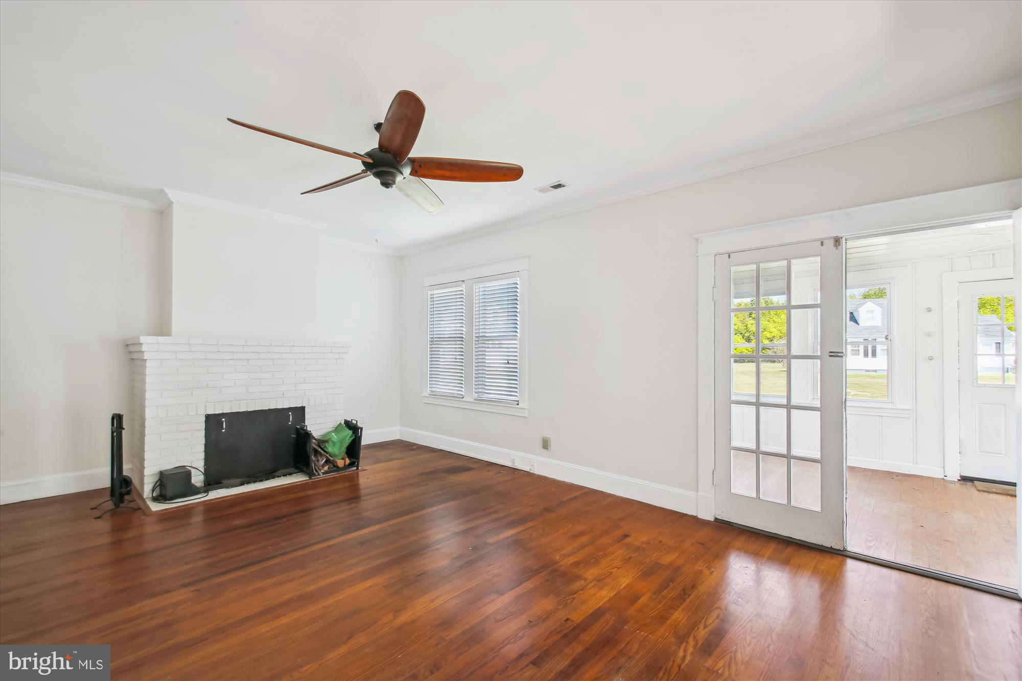 611 Clark Avenue Deale, MD 20751 - Photo 14 of 37 a view of empty room with fireplace and wooden floor