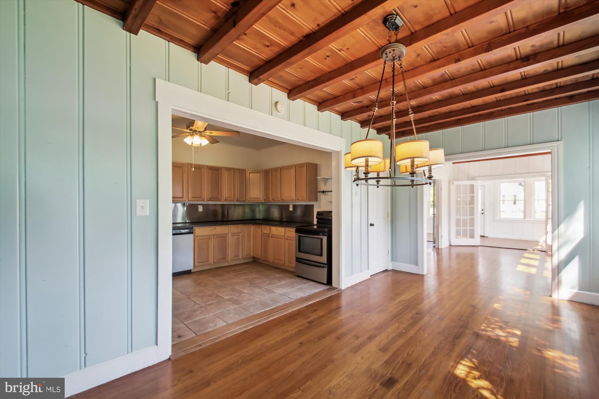 611 Clark Avenue Deale, MD 20751 - Photo 16 of 37 a view of a kitchen with a refrigerator and a wooden floor