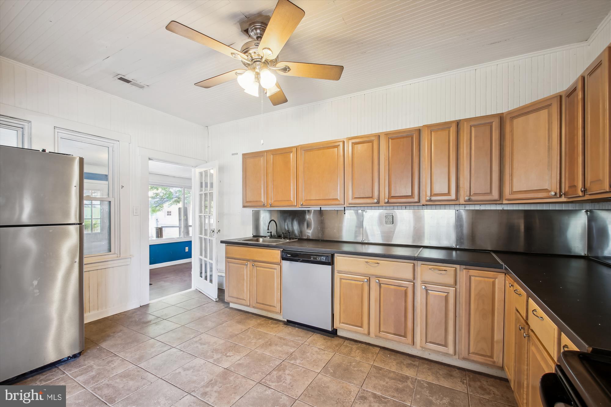 611 Clark Avenue Deale, MD 20751 - Photo 20 of 37 a kitchen with stainless steel appliances granite countertop a refrigerator a sink a stove with white cabinets