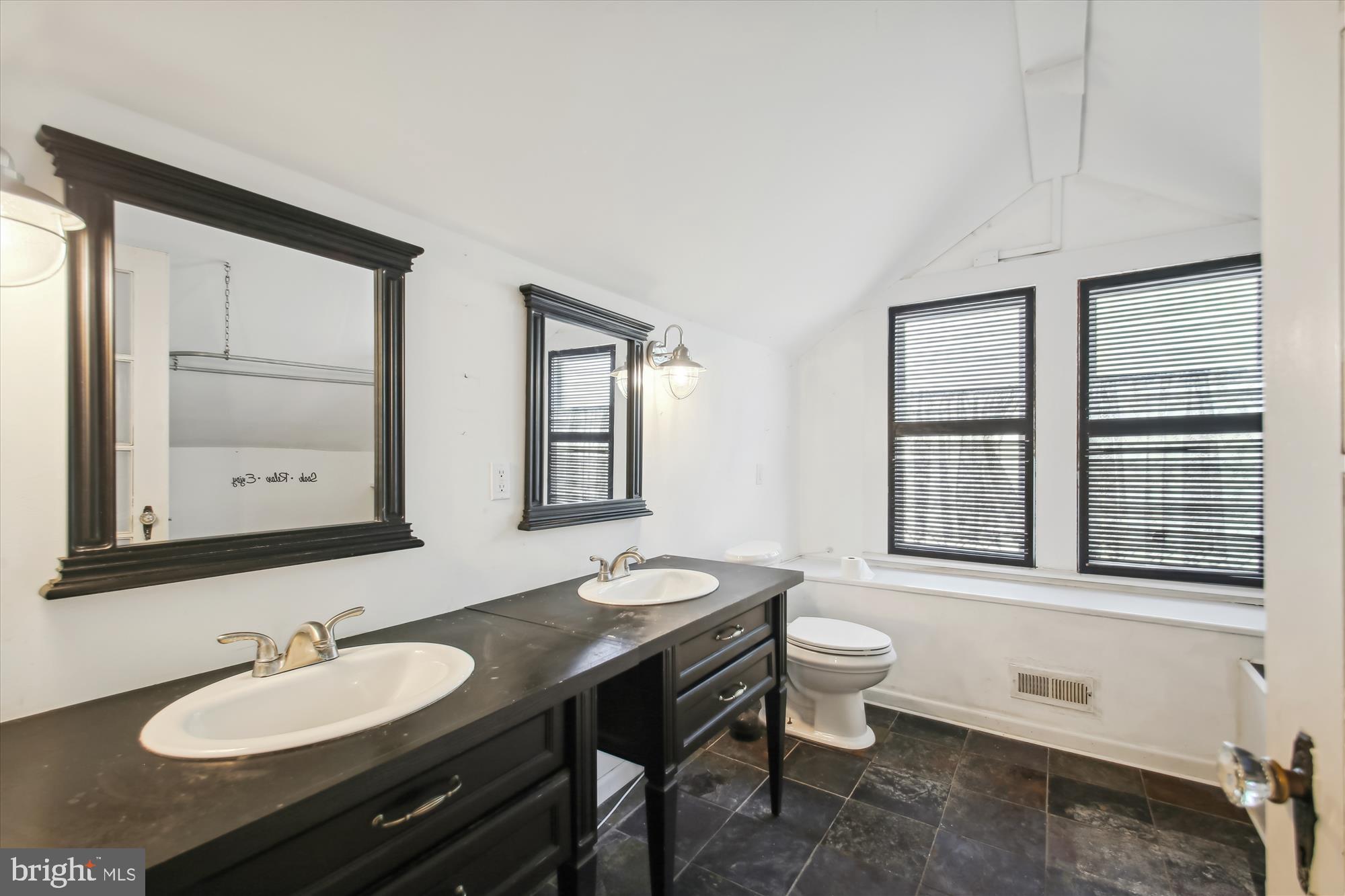 611 Clark Avenue Deale, MD 20751 - Photo 27 of 37 a bathroom with a sink a toilet and mirror