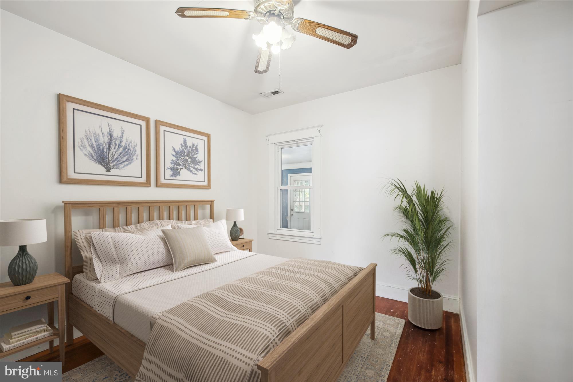 611 Clark Avenue Deale, MD 20751 - Photo 9 of 37 a bedroom with a large bed and a chandelier