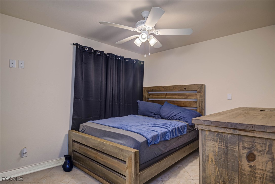 2019 Clark Avenue Fort Myers, FL 33905 - Photo 11 of 23 a bedroom with a bed and a chandelier
