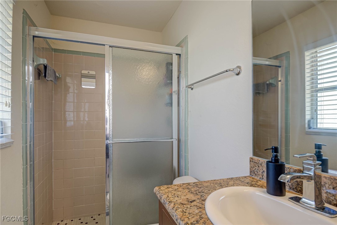 2019 Clark Avenue Fort Myers, FL 33905 - Photo 14 of 23 a bathroom with a granite countertop shower sink and mirror