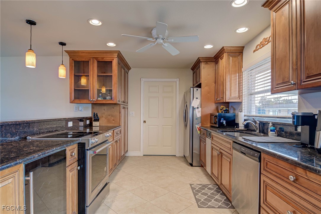 2019 Clark Avenue Fort Myers, FL 33905 - Photo 7 of 23 a kitchen with stainless steel appliances granite countertop a sink a stove and a refrigerator
