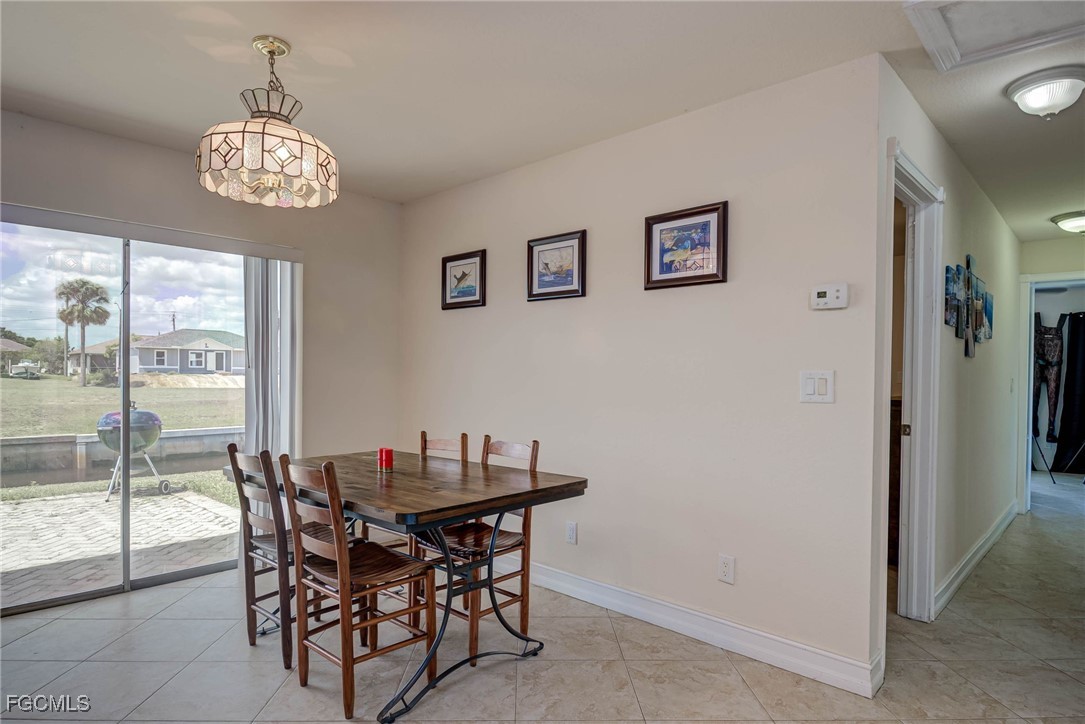 2019 Clark Avenue Fort Myers, FL 33905 - Photo 10 of 23 a dining room with wooden floor and a chandelier