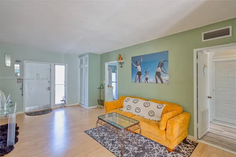 a kitchen with refrigerator and cabinets