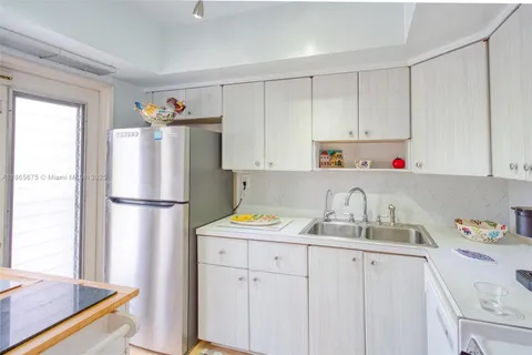 a kitchen with a sink cabinets and appliances