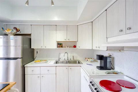a kitchen with a sink cabinets and window