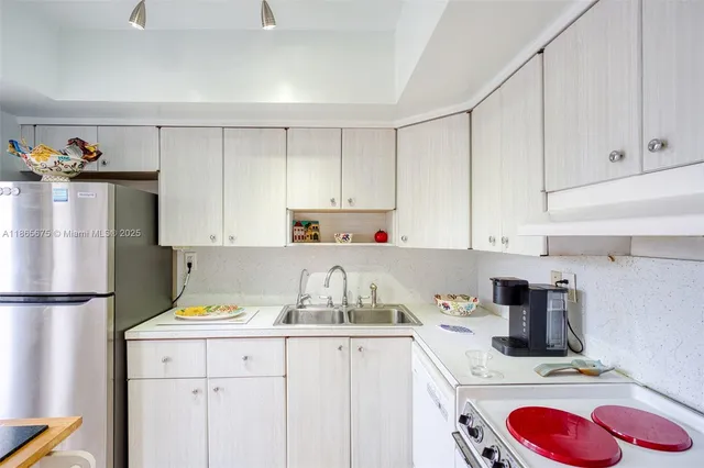 a kitchen with a sink cabinets and window