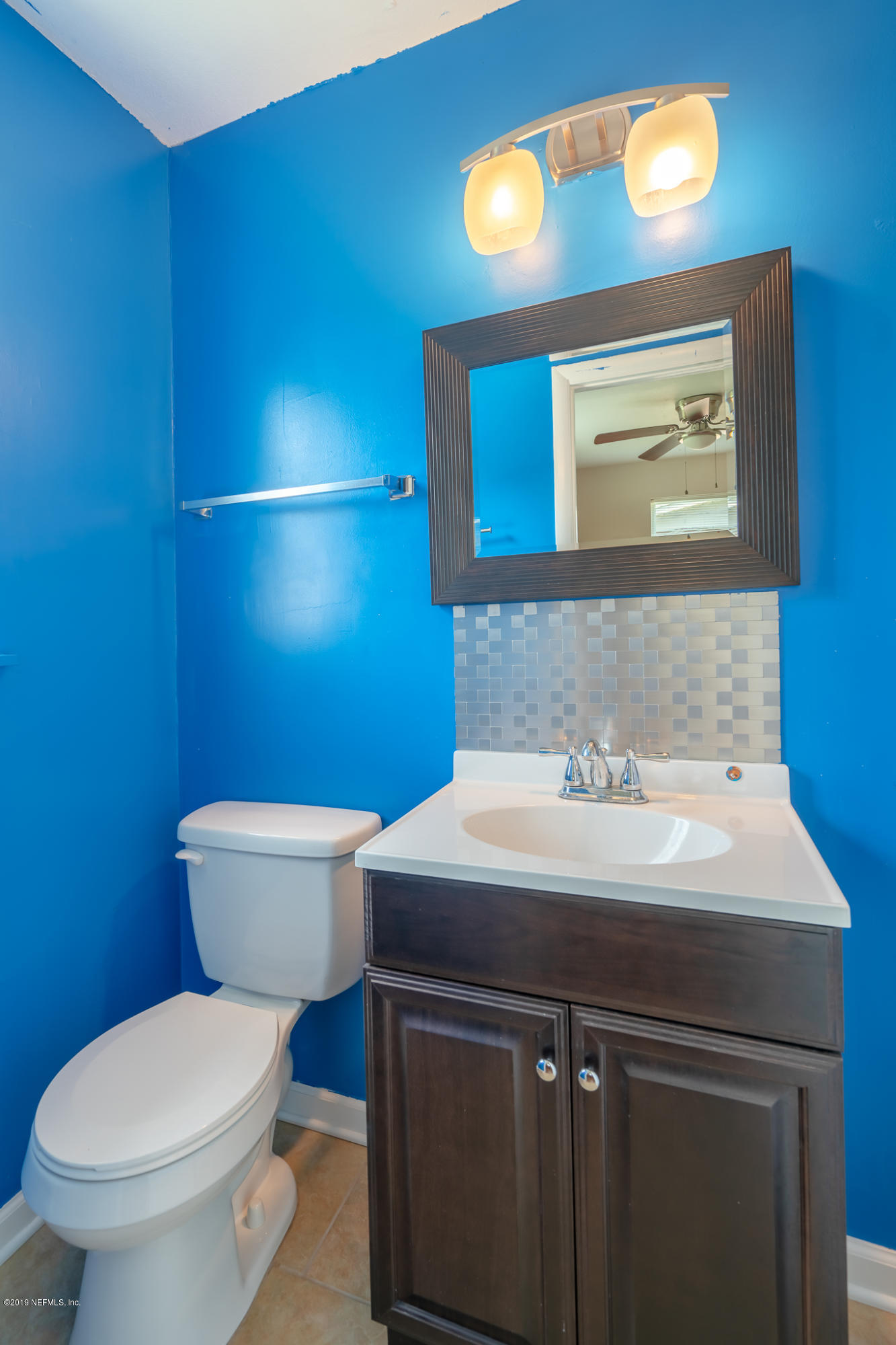 4519 Barnes Road South Jacksonville, FL 32207 - Photo 22 of 46 a bathroom with a sink a toilet and mirror