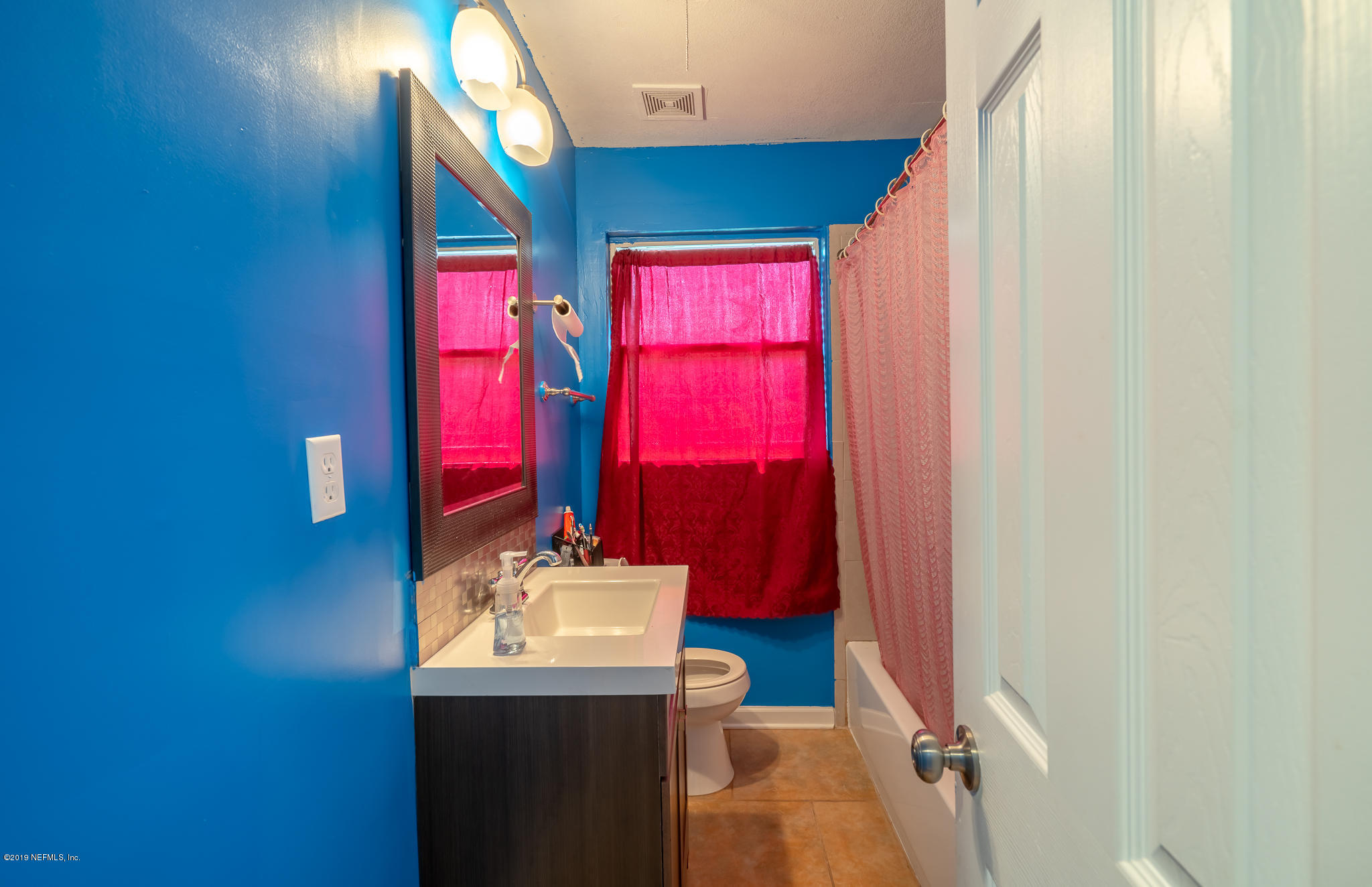 4519 Barnes Road South Jacksonville, FL 32207 - Photo 27 of 46 a bathroom with a sink vanity and a mirror