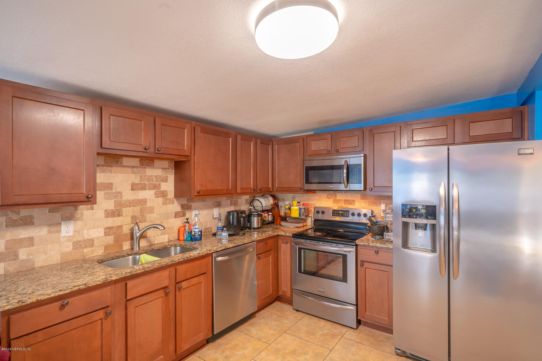 4519 Barnes Road South Jacksonville, FL 32207 - Photo 9 of 46 a kitchen with stainless steel appliances granite countertop a refrigerator sink and stove