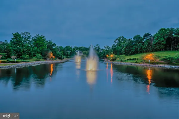 a view of a lake with houses in the back