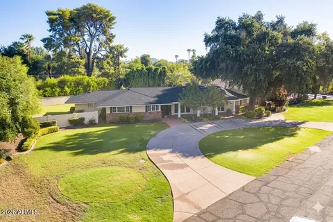 a house view with swimming pool and trees in the background